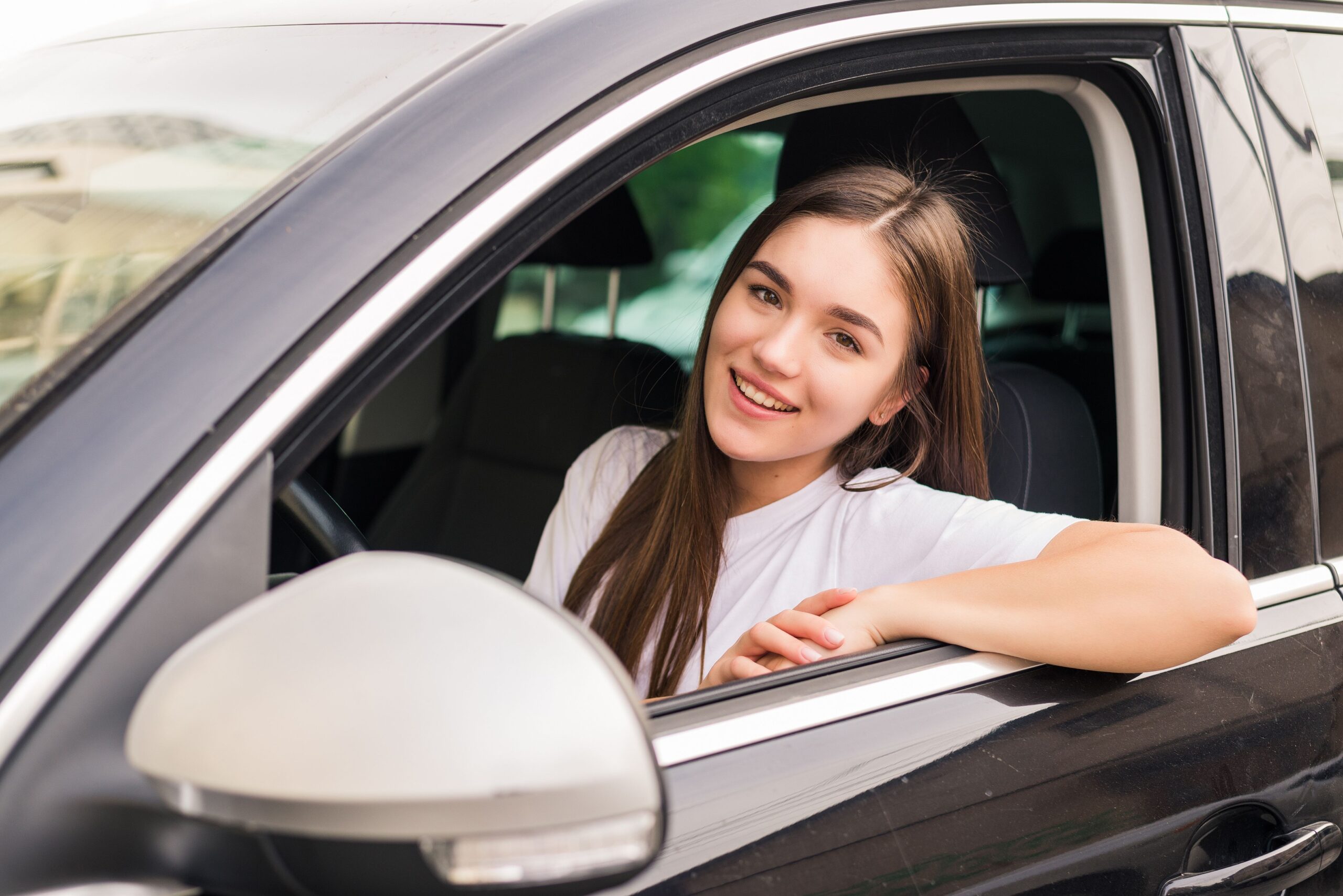 Young woman driving her car on trip road