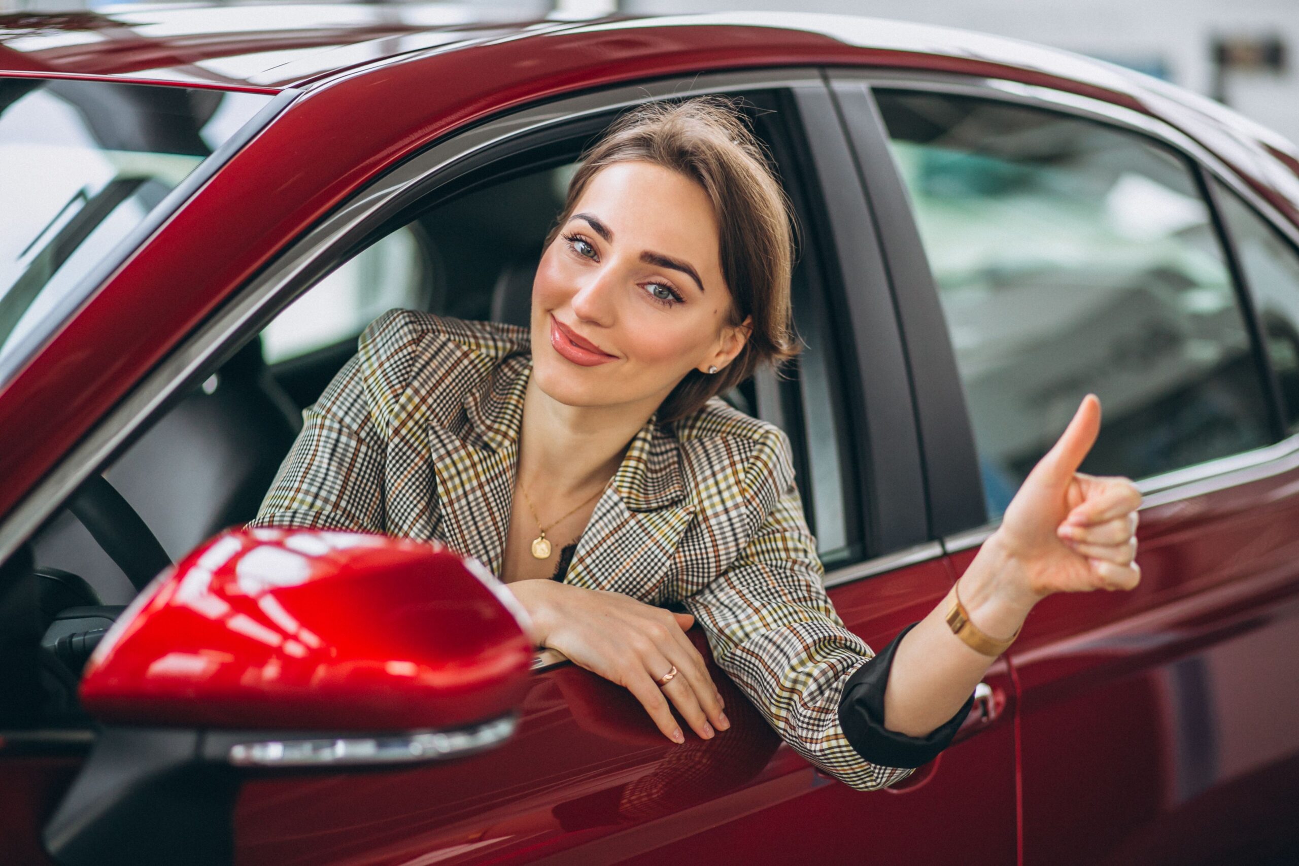 Woman sitting i car in a car showrrom